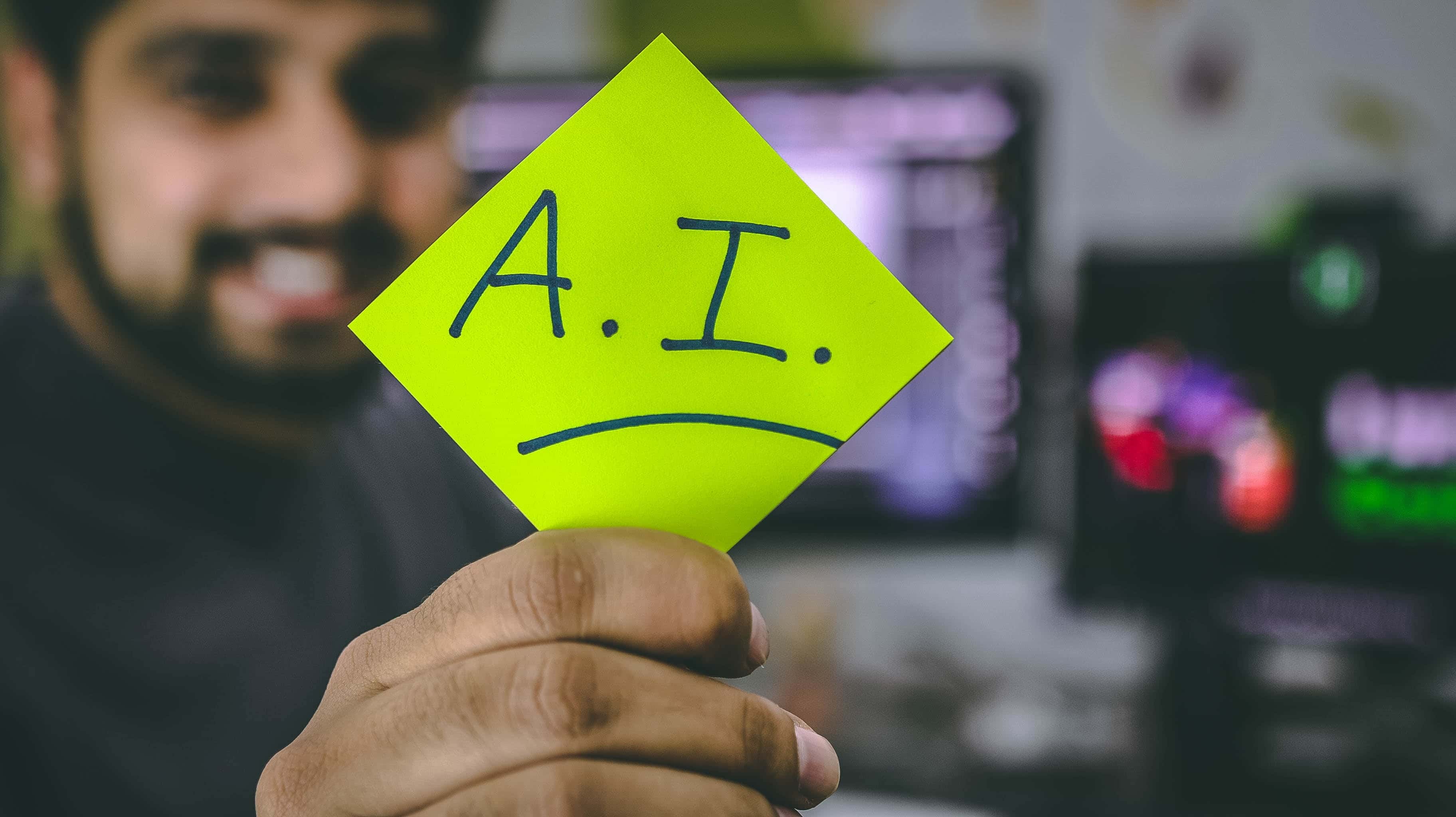 A person holding an AI sign on a paper